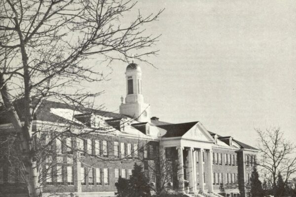 Black-and-white cover of Alumnus, published by Siena College (March 1967), featuring a winter view of a campus building with columns and a central cupola, surrounded by bare trees and snow.